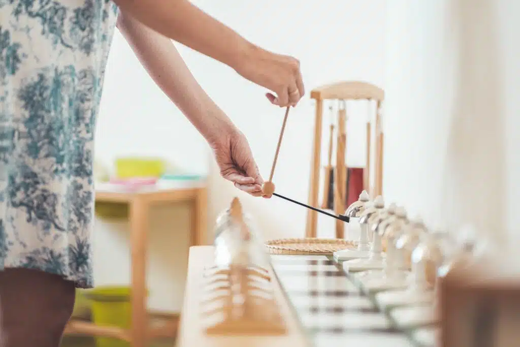 A Montessori trainer presenting the bells, a sensorial material