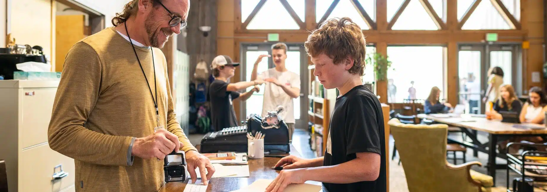 Adolescent students and guide at Compass Montessori