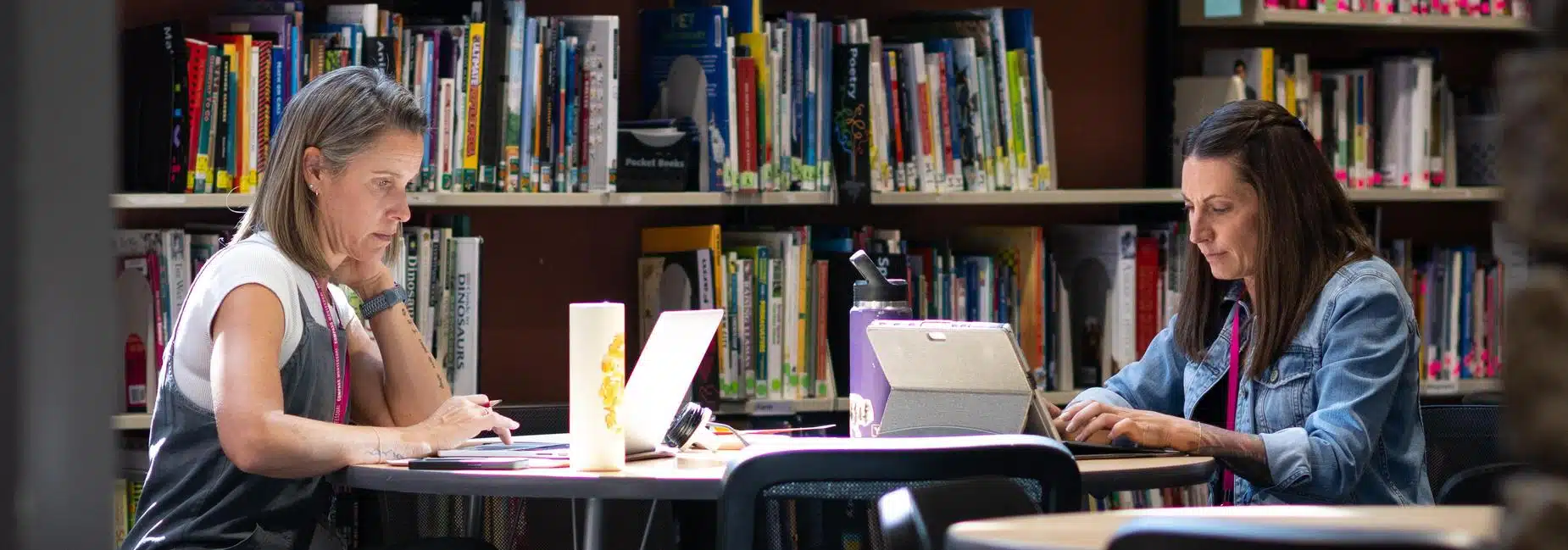 Students working in the Compass Montessori library