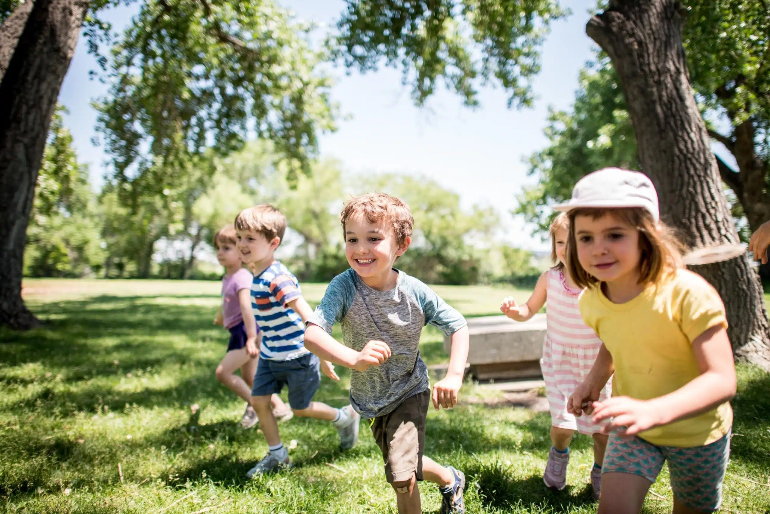 Children running outdoors at Compass Montessori